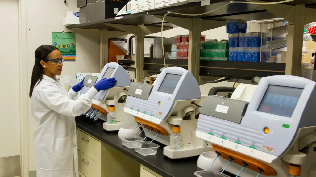 Bacterióloga operando analizadores en un laboratorio clínico